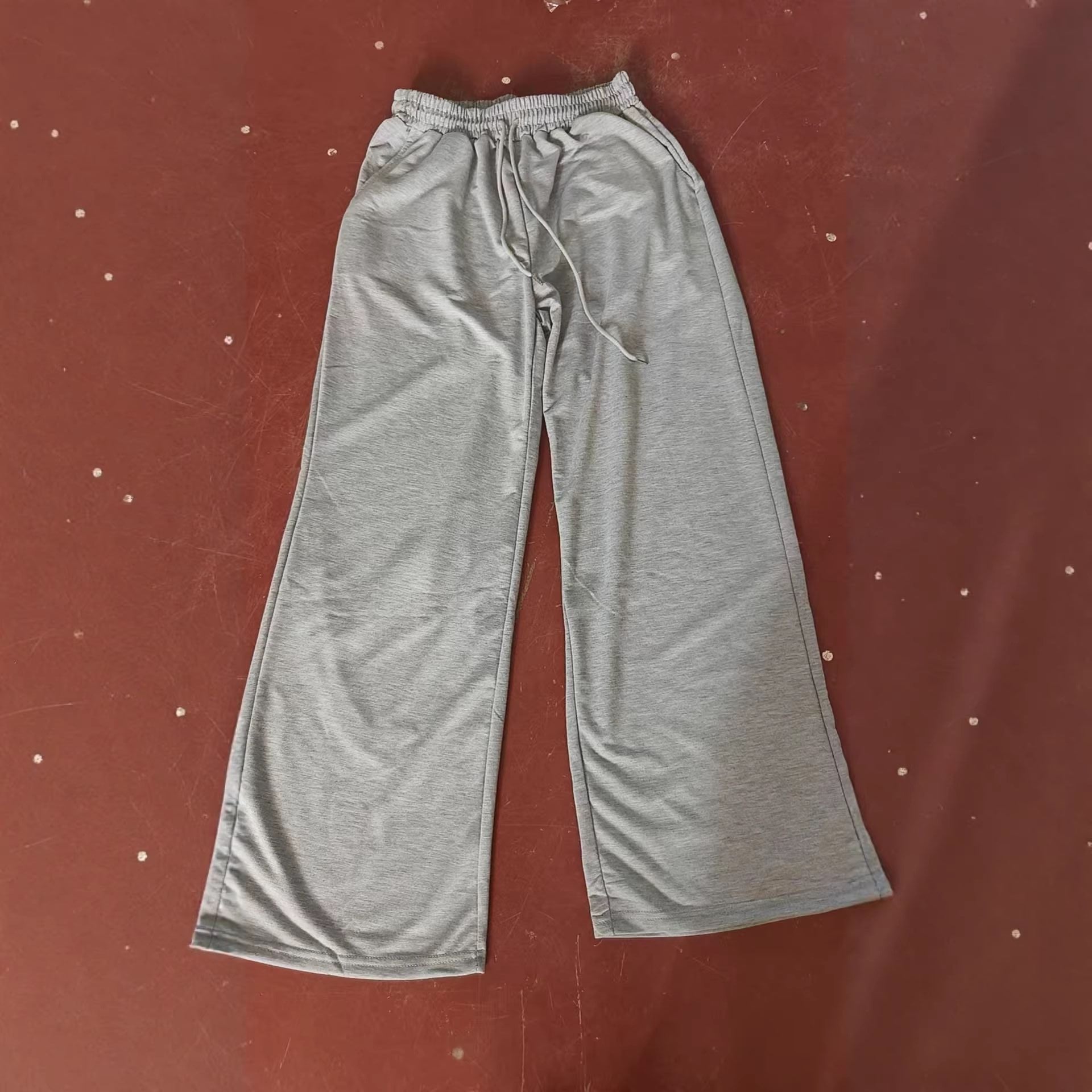 Ladies' pure-colored, waist-fitting, fashionable wide-leg, warp-knitted casual pants with drawstrings, suitable for home wear
